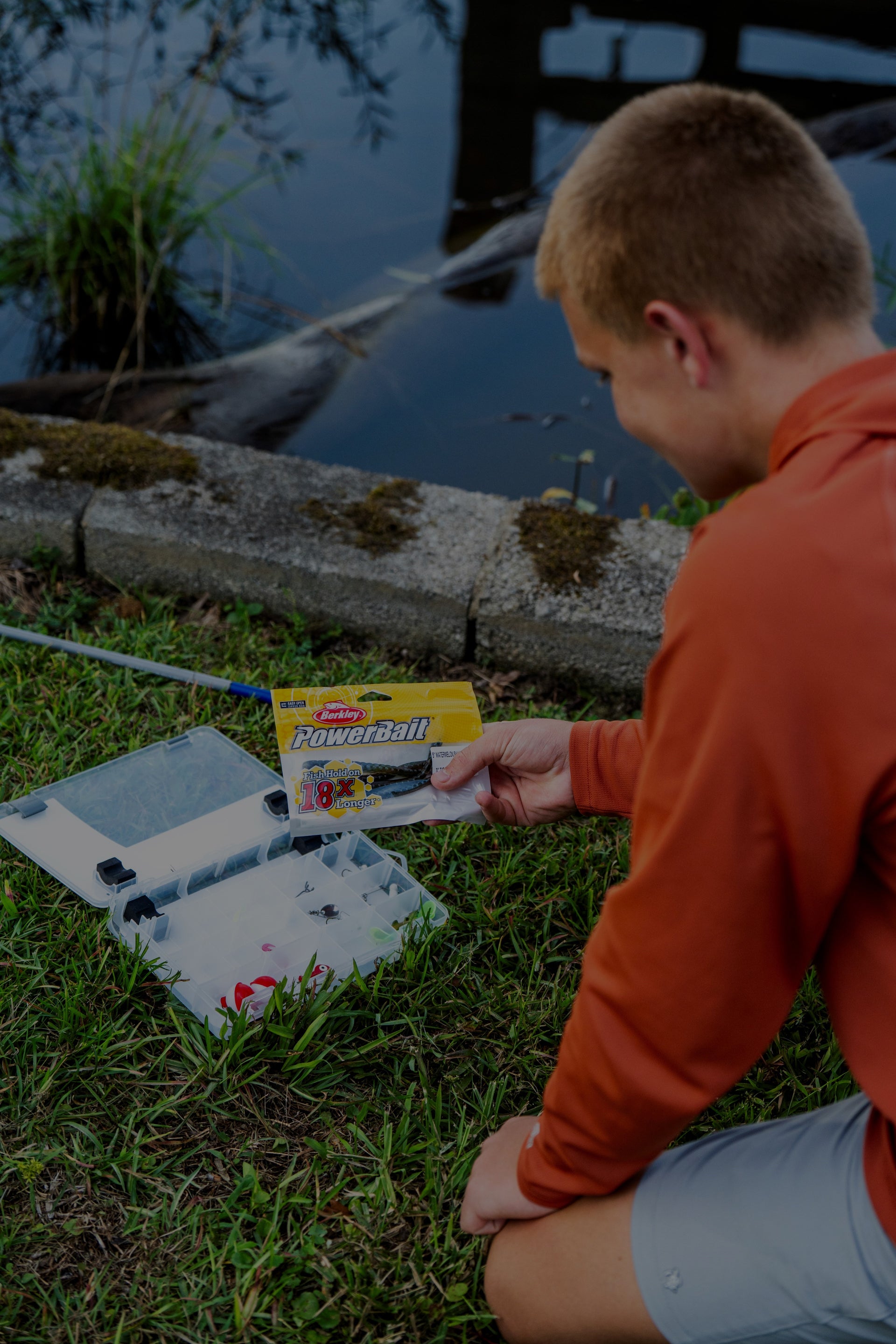 Person holding a box of Powerball tickets by a lake